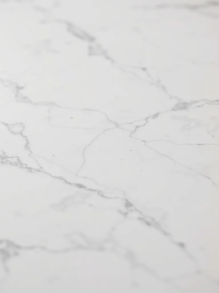 Macro shot of a polished white marble surface with subtle gr